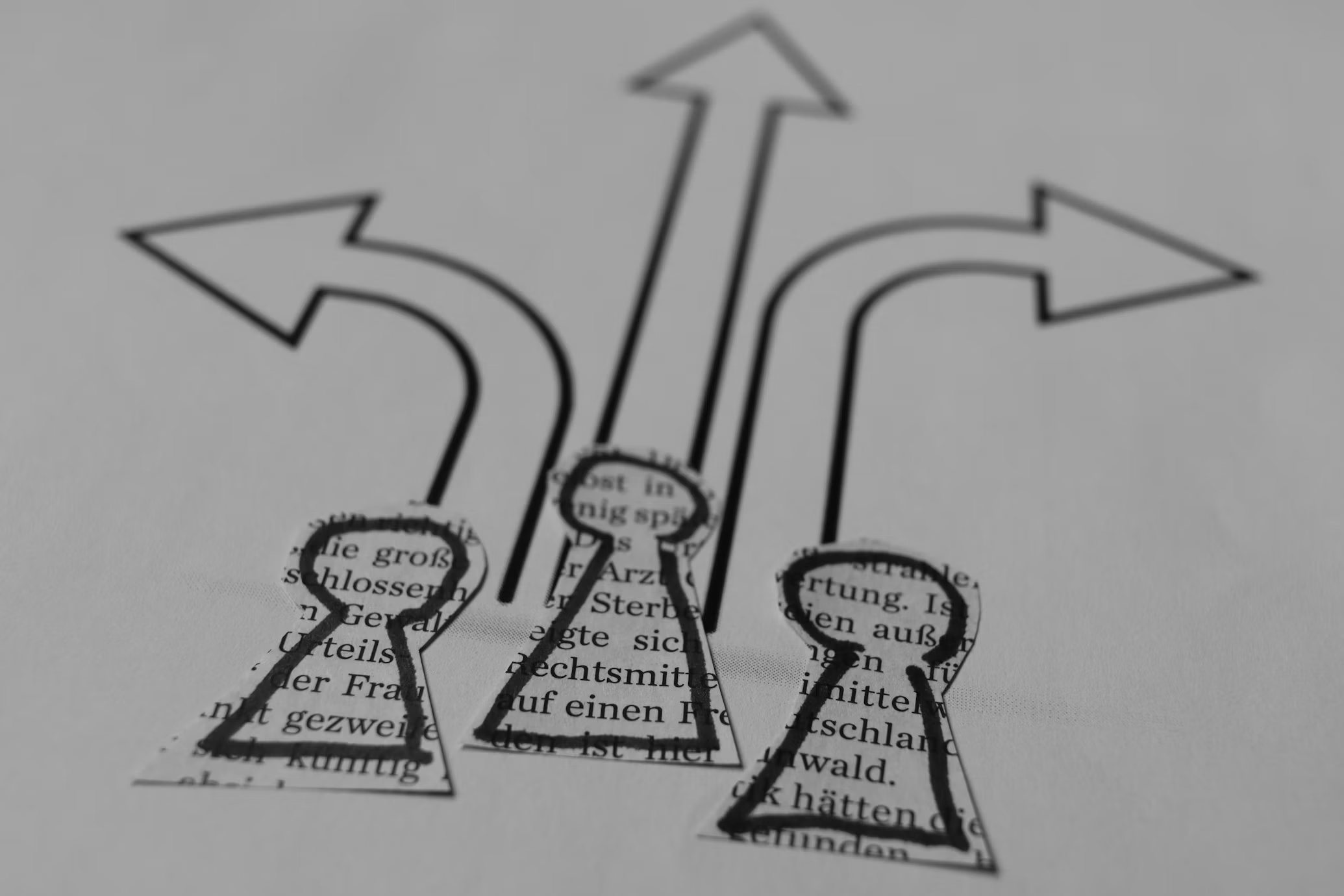 Three paper figures with arrows drawn behind them